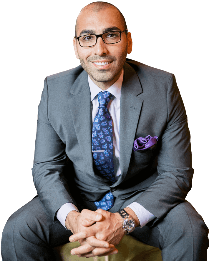 A sitting man wearing a suit and transparent eyeglasses