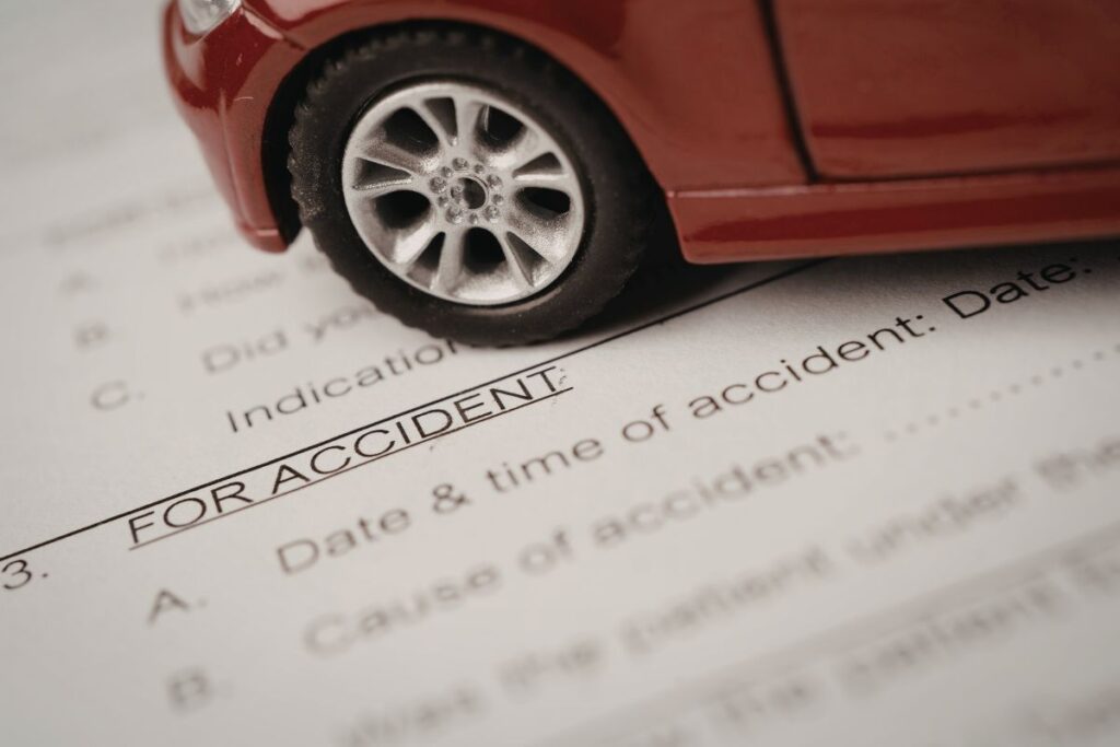 an accident report form under a car model, showing how official documentation supports Uber and Lyft injury claims in San Diego.