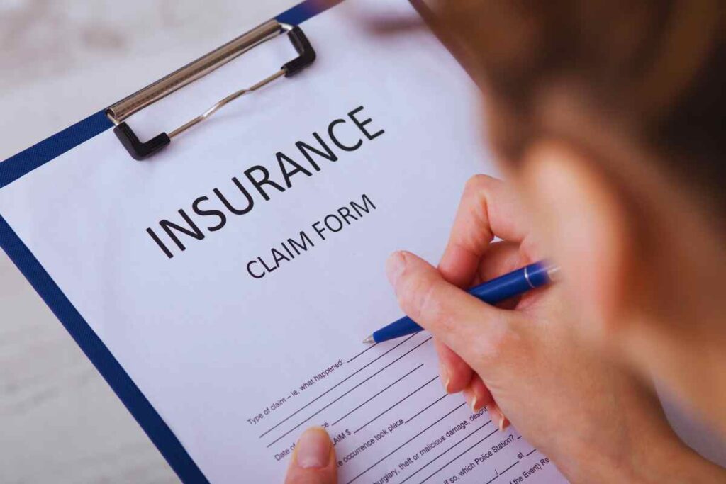 Person filling out an insurance claim form after an Uber or Lyft accident, documenting details for a rideshare injury claim in San Diego